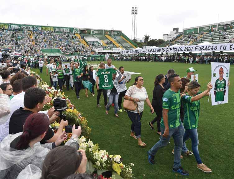 () Relatives of the members of the Chapecoense Real football club team killed in a plane crash in Colombia enter the field during a funeral ceremony at the stadium in Chapeco, Santa Catarina,
