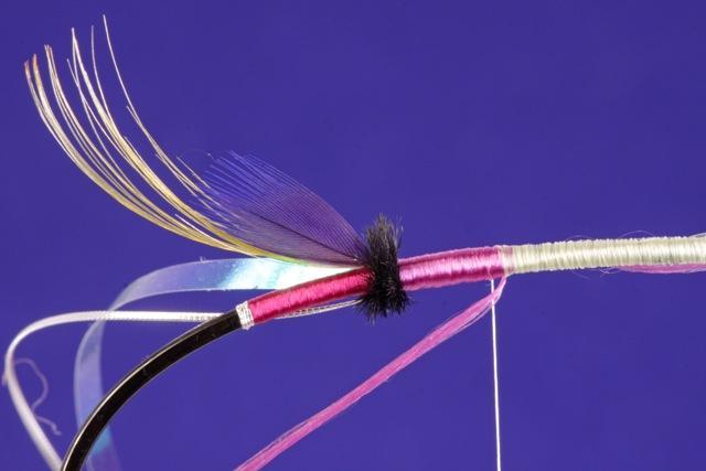 Wrap the tying thread to the return trapping the tinsel, floss, and ostrich herl as you go. Return the tying thread to the rear 1/4 point.