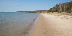 N FISHERMAN S ISLAND STATE PARK 16480 BELLS BAY ROAD, CHARLEVOIX, MI 49720 Sandy Lake Michigan beach meets rustic forest at Fisherman s Island State Park in Charlevoix,