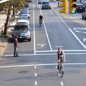 Some lanes have a painted buffer to further separate cyclists from moving vehicles.