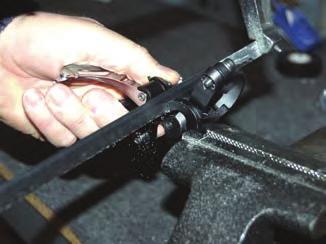The best method we have found is to clamp the derailleur by the bottom-pull arm [ as pictured to the