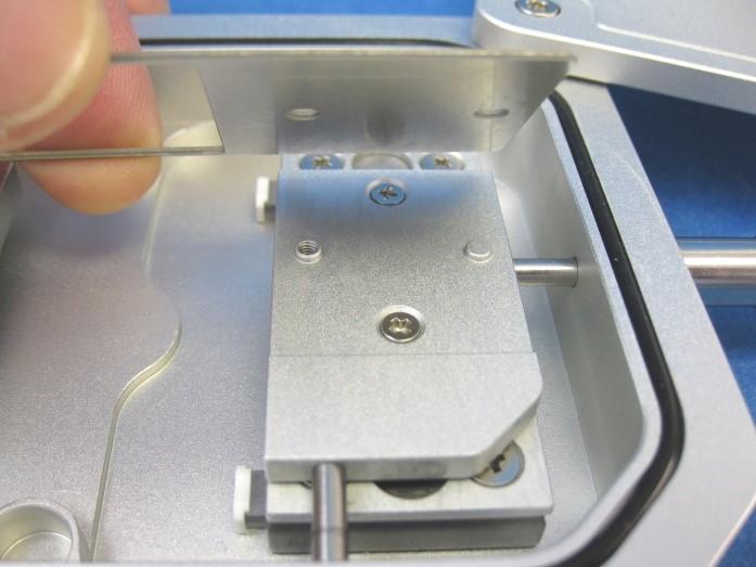 Replacing the Microscope Slide Holder Use a flat screw diver and remove the screw (1).