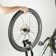 Attaching the front wheel Place the frame upside down on a flat surface, resting on the saddle and the