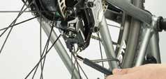 Place the frame upside down on a flat surface, resting on the saddle and