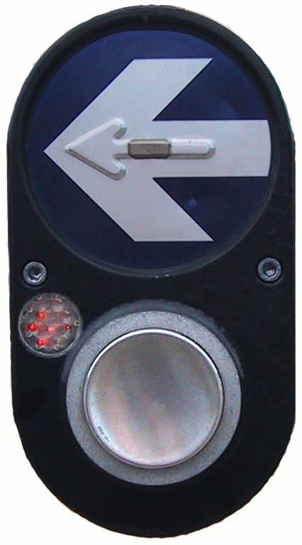 APS unit mounted on top of pedhead. Figure 3. Pushbutton-integrated APS. Figure 4. Bottom view of a vibrotactile APS showing a raised arrow that vibrates. Figure 5.