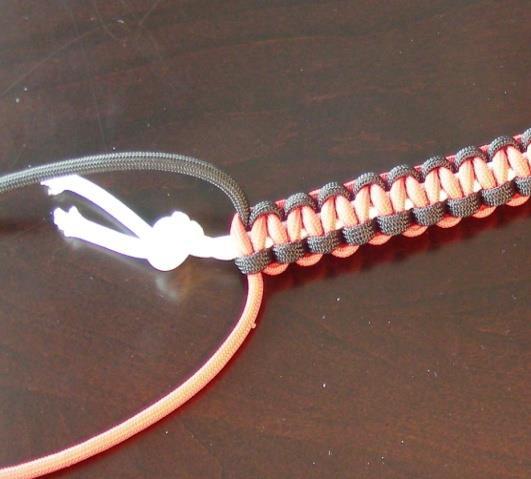 Step 10 Now we ve reached the white cord s overhand knot. At this point, check the bracelet s fit around your wrist.