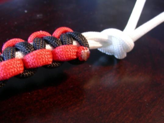 Or you may need to unweave the red/black cords a couple of times. Adjust it so it fits comfortably around your wrist.