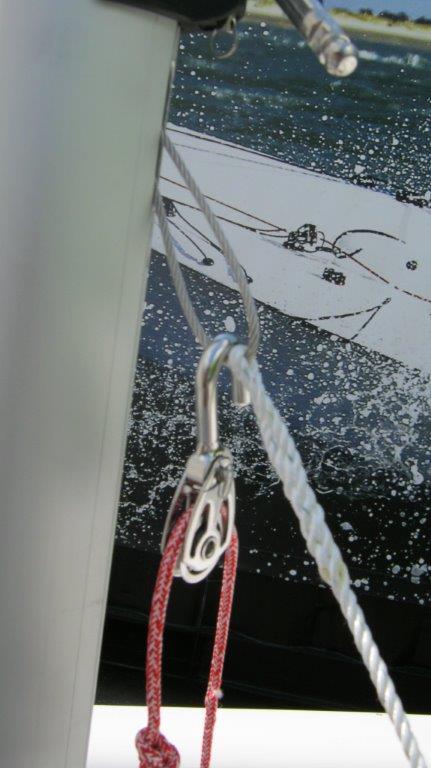 4. Pull the halyard at the base of the mast to hoist the jib.