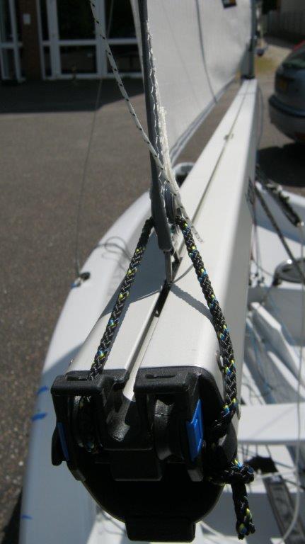 Tie a simple half hitch in the end and secure it under the slot in the