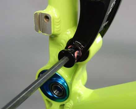 Slide the rear triangle over the integrated axles and align it with the pivot