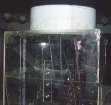 For maintaining the similarity of fluctuating internal pressures between the wind tunnel test and full scale test, a chamber was added to wind tunnel test model under floor as shown in Figure 2 by