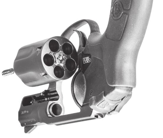 Press the thumbpiece forward and push the cylinder to the left (FIGURE 6). You must verify that all charge holes are free of live rounds and the barrel is free of any obstructions.