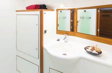 Owner s en-suite head, located on port side, with a regular sized manually operated marine toilet, moulded sink with single lever luxury mixer tap, cupboard and mirror.