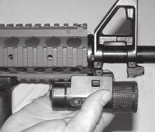 Bring the M3X up and toward the firearm, aligning the grooves of the M3X and the rail grooves on the firearm; slide the M3X straight back until the latch engages into the locking slot