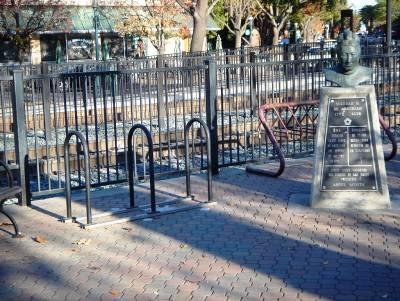 Bicycle lockers on elevated concrete pads are located in the parking lot across Broadway from the station.