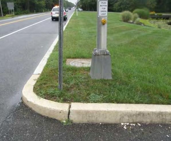 (where there is a crossing of each roadway), however, one curb ramp constructed at the center of the curb