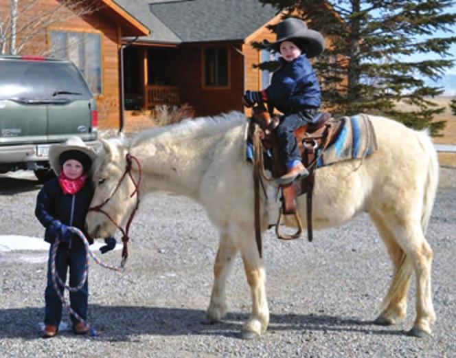 Patient teachers ) Erin Thee,, with her pony, Biscuit, 5, waiting to