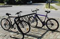 Generally, optimum bicycle parking devices / facilities should: Enable the bicycle to be securely locked to the device without damaging the bicycle; Be placed along commercial arterials, employment