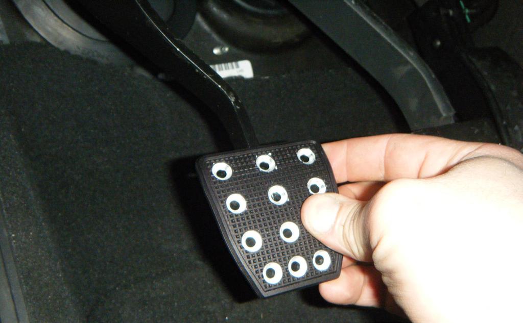3. Line up the supplied gas pedal cover on the gas pedal and mark the location of the four screw holes with a silver marker, as