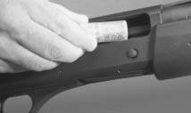 FIGURE 8 When loading the chamber directly, drop a loaded round in the open ejection port. Before loading the magazine make sure of the following: 1) Your shotgun is pointed in a safe direction.