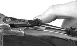 To insert rounds in the chamber, move the top lever to the right with the thumb of your firing hand and open the breech.