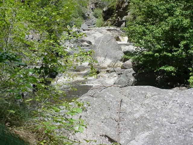 Figure 54: Upper falls is located in the right center of picture. Access to this location would require free climbing over very large boulders and through swift currents.