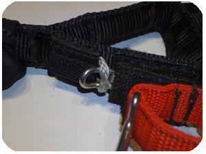 2. With the oval ring extended through the webbing sleeve continue to push it upwards until it passes through the small grey rope loop.