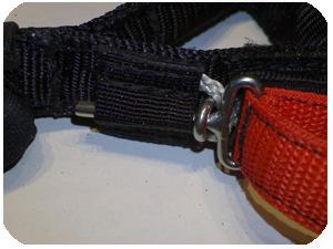 With the oval ring correctly inserted through the grey rope loop, take the red webbing handle and slide the pin of the QR through the oval ring and then upwards through the webbing sleeve on the body