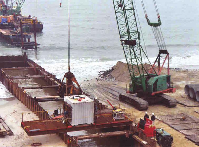 Crane used for clamshell excavation and subaqueous pipe laying. pipeline. Acceptable methods include an infiltration test or an internal pressure hydrostatic test.