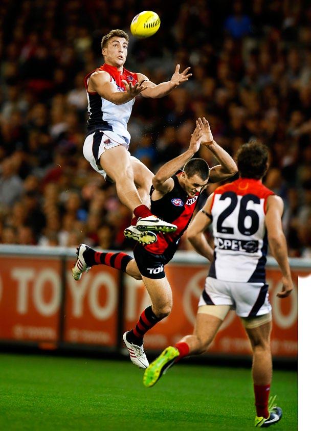Melbourne youngster Jack Viney soars over Essendon s Brent Stanton in round two at the MCG.