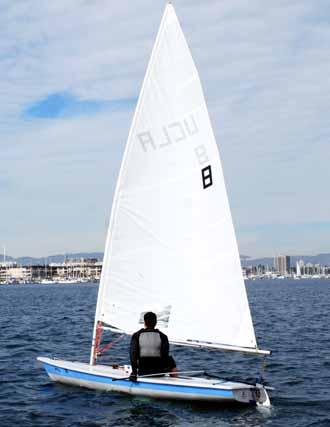 Release the tiller with the old hand and take hold of the mainsheet