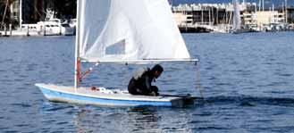 The sailor moves his weight out onto the daggerboard so that the boat begins to right. Mast rises out of water 2.