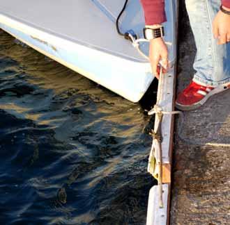 34. Attach the daggerboard retention line from the bow to the daggerboard. Daggerboard Retention line 32.