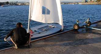 Walk your hands along the boom until you reach the gooseneck and remove the boom from the mast. Place the boom on the deck.