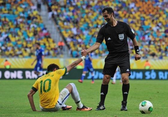 Referee Ravshan Irmatov helps Neymar of Brazil to his feet during the FIFA Confederations Cup