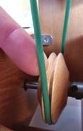 looking at the bamboo side of the drive wheel, you need to put the belt on in such a way that