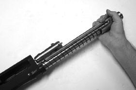 Insert the screwdriver or back of empty cartridge into the notch and pry up handle and remove from the bolt or grasp the handle firmly and pull out and away from the receiver.