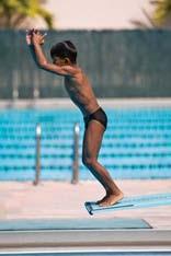 Two-part Takeoff with Forward Dive Tuck from Springboard Fig. 8-22A Throw your arms overhead to propel your upper body, arms and head into the tuck position. Fig. 8-22B Assume the tuck position. Fig. 8-22C Enter the water in a streamlined position.