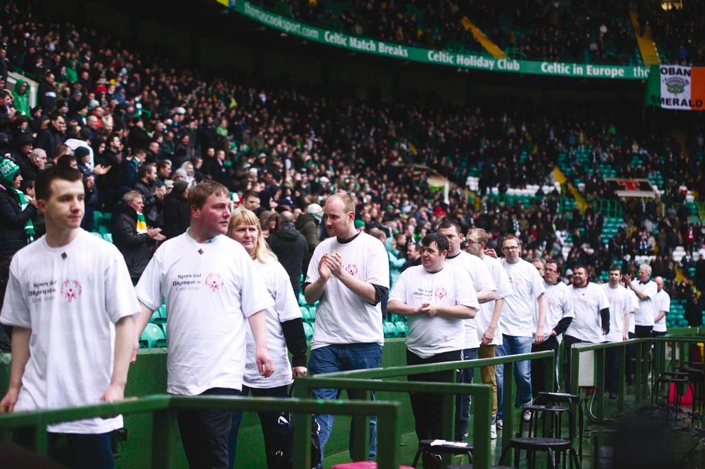 Celtic FC fans applaud Special Olympics athletes pitch side at Celtic Park during the