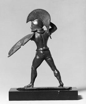 Instead of the circular hoplite shield of wood, this statuette has the lighter, oblong, scalloped Boeotian shield, apparently made of wicker or leather.