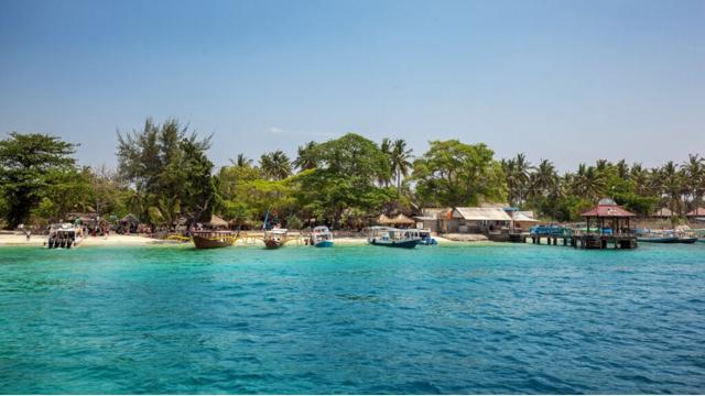 THE GILI ISLANDS The Gili Islands are a collection of three miniscule desert islands, famous for their white sand beaches, coconut palms, and glimmering turquoise waters.