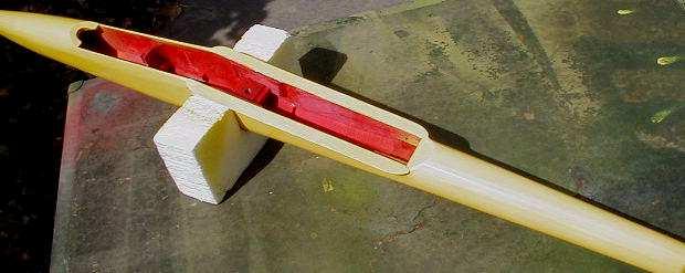 The fuse was first masked to repaint the interior red. Then this was shielded with cardboard to spray yellow on the horizontal edges where the canopy and wing go.