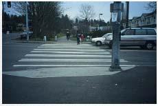 Figure 8-10. ACCEPTABLE DESIGN: Although crosswalks with parallel markings are permitted by the MUTCD, they are less visible to motorists than crosswalks with ladder striping. 8.5.