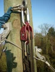 Ascend the pole (as per operating procedure) and secure the pulley with the loose end of rope to the eye bolt at the top using the large