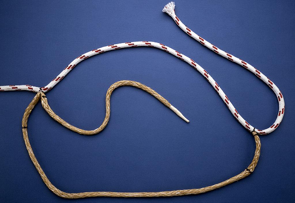 1) Step #2 - Extract the core at mark by bending rope sharply and carefully spreading the cover strands to expose the core. Then pry the core braid out using the pointed end of the fid.