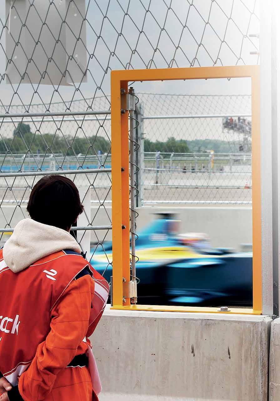 SPECIAL MOTORSPORT SOLUTIONS. Formula E, Berlin: A track marshal watching the race through a special gate opening, 2015.