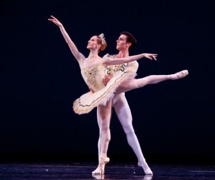 In Balanchine s Theme and Variations, we see traditional Classical Ballet partnering where the man is helping the woman stay on pointe and lifting her high in the air.