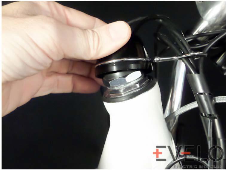 This pulls the small wedge now inside the bike up snug to secure the handlebar assembly. 4. The bolt shown in Fig. 6 can be loosened to adjust the position of the handlebars.