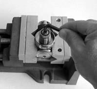 Turn the yoke screw counter-clockwise to remove it from the yoke, and set aside the breaker bar and socket. c. Unscrew the yoke retainer counter-clockwise to remove from the body, along with the yoke and saddle(10).