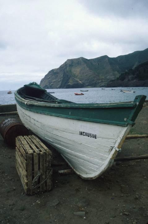 A traditional wooden fishing boat hauled out in the dry dock area.